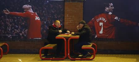 Fans enjoy a pre-match snack outside the grounds before the English Premier League soccer match between Manchester United and Burnley at Old Trafford in Manchester, northern England February 11, 2015. REUTERS/Phil Noble