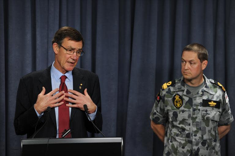 Retired Australian air chief marshall Angus Houston (L), with Australian Commodore Peter Leavy (R), updates the media on the search for flight MH370 at a press conference in Perth on April 4, 2014