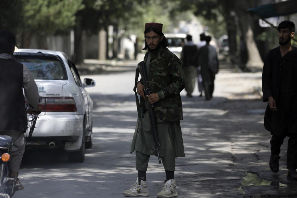 A Taliban fighter stands guard at a checkpoint in the Wazir Akbar Khan neighborhood in the city of Kabul, Afghanistan, Sunday, Aug. 22, 2021. A panicked crush of people trying to enter Kabul's international airport killed several Afghan civilians in the crowds, the British military said Sunday, showing the danger still posed to those trying to flee the Taliban's takeover of the country. (AP Photo/Rahmat Gul)