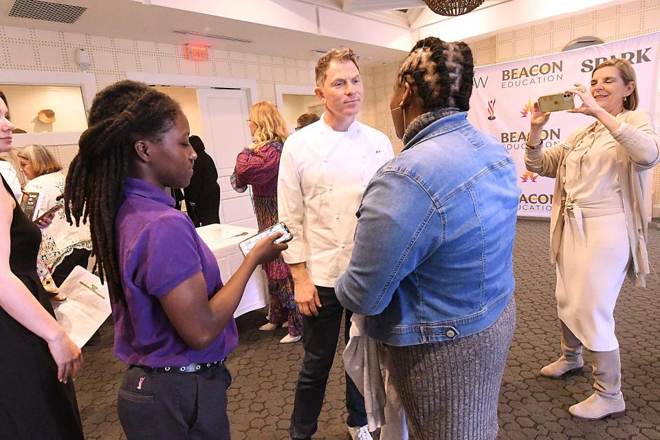 Bobby Flay poses for photos with fans as he headlined a breakfast and lunch event at the Country Club of Landfall to support GLOW Academy and Beacon Education.