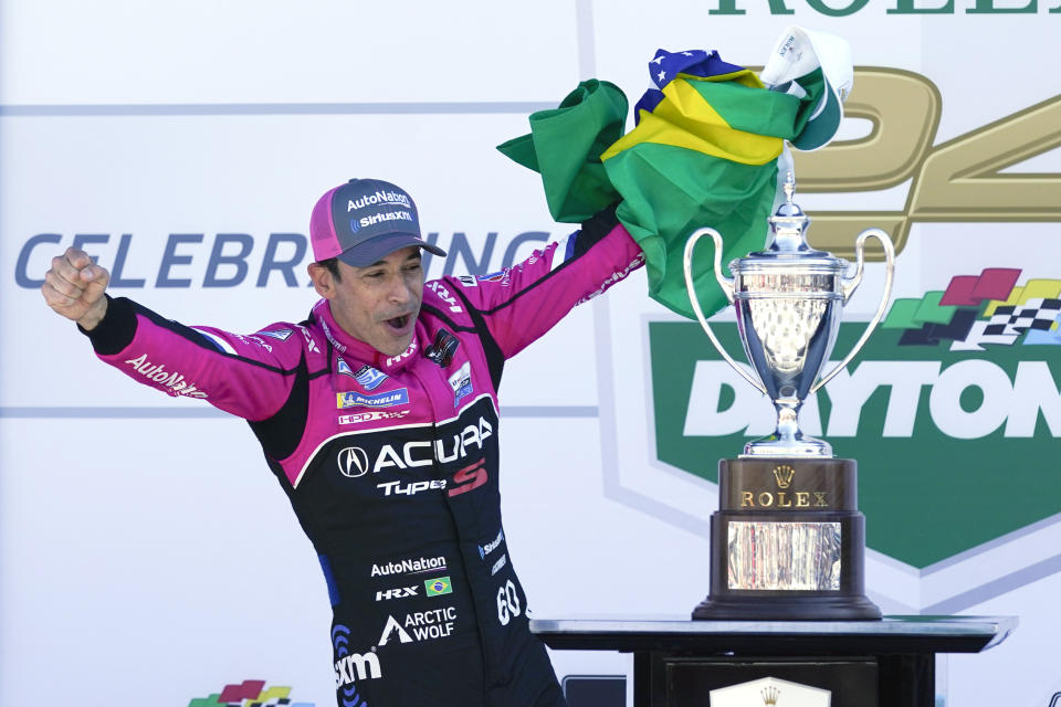 Helio Castroneves, of Brazil, celebrates in Victory Lane after winning the Rolex 24 hour auto race at Daytona International Speedway, Sunday, Jan. 30, 2022, in Daytona Beach, Fla. (AP Photo/John Raoux)