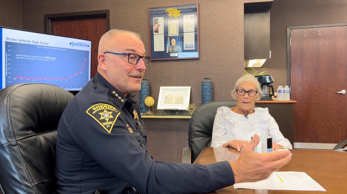 Monroe County Sheriff Todd Baxter talks with Chili resident Barbara Wise, whose Hyundai Elantra was stolen last month, during a roundtable discussion with news media on Oct. 26, 2023. Wise recently retired but had to go back to work part-time to make up for the financial loss.