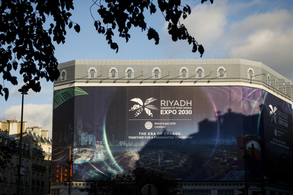 A canvas decorated with a commercial promoting the Riyadh Expo 2030 protects a building under renovation, Tuesday, Nov. 28, 2023 in Paris. In a high-profile showdown, Rome, Busan and Riyadh are the top contenders to become the host city of the 2030 World Expo, with the organizing body choosing the winner on Tuesday. (AP Photo/Thomas Padilla)