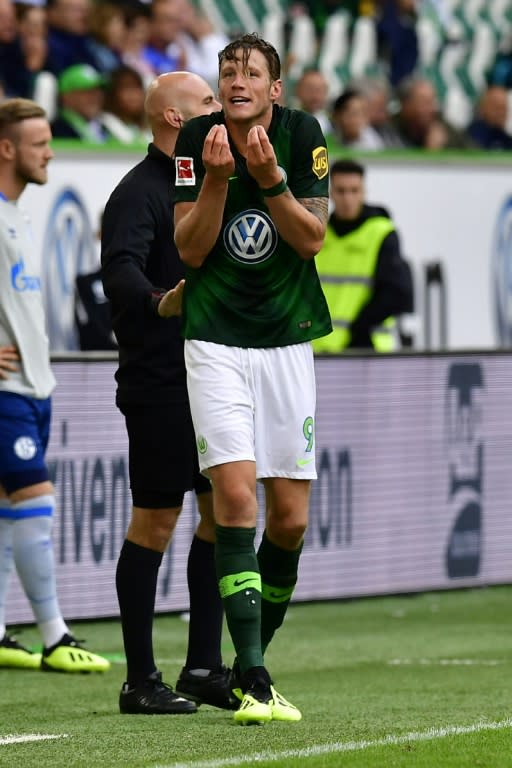 Wolfsburg's Dutch forward Wout Weghorst was initially shown a red card in Saturday's 2-1 win over Schalke, which was later downgraded to a yellow card after the VAR intervened