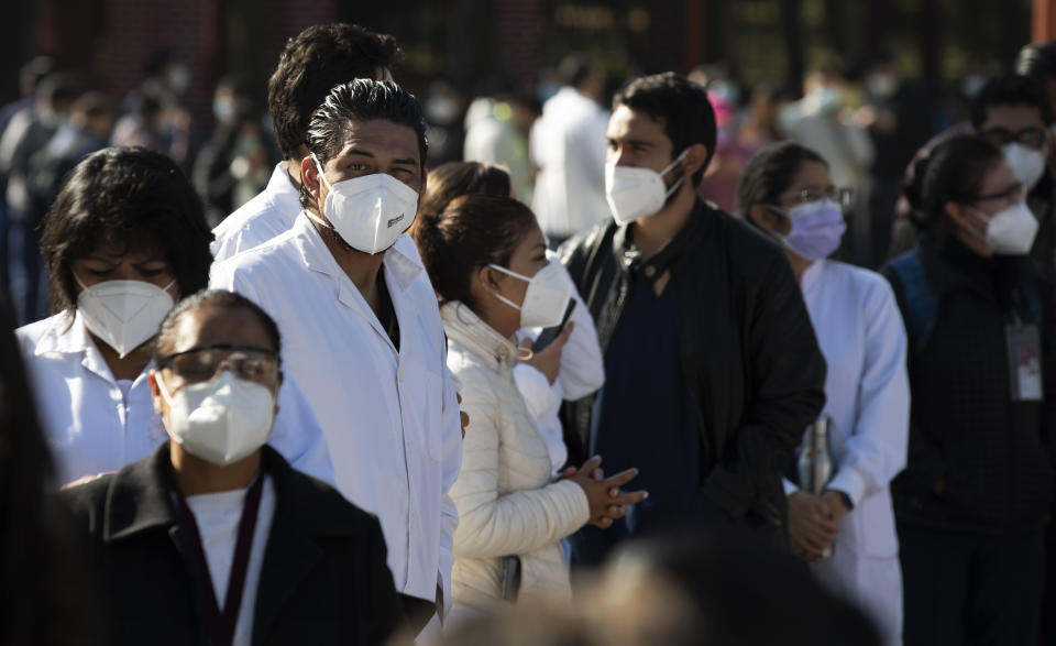 Health workers and soldiers wait to be given the Pfizer-BioNTech vaccine for COVID-19 at the N-1 military base in Mexico City, Wednesday, Dec. 30, 2020. (AP Photo/Marco Ugarte)