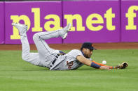 Detroit Tigers' Victor Reyes makes a diving attempt on a single by Cleveland Indians' Greg Allen during the eighth inning of a baseball game, Saturday, Aug. 22, 2020, in Cleveland. (AP Photo/Ron Schwane)