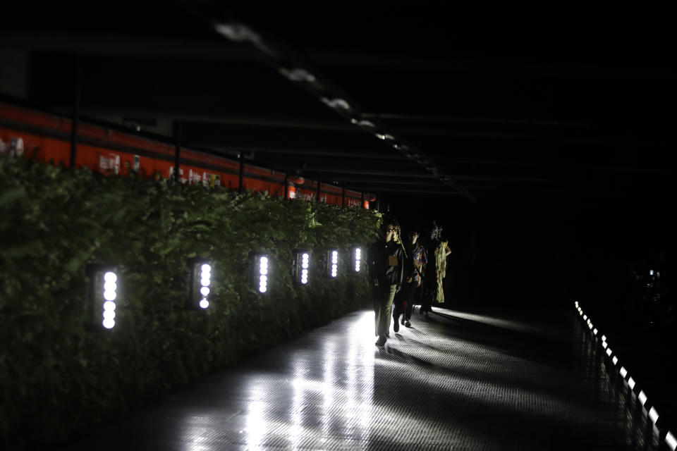 Models wear creations as part of the Palm Angels men's Spring-Summer 2020 collection, unveiled during the fashion week, in Milan, Italy, Sunday, June 16, 2019. (AP Photo/Luca Bruno)