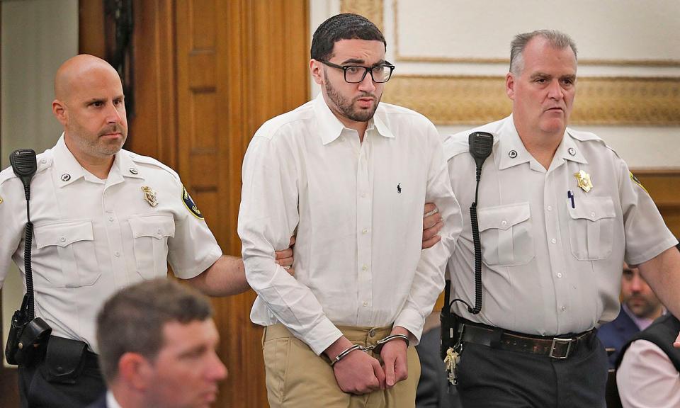 Emanuel "Manny" Lopes is escorted into court in Dedham on Thursday, June 8, 2023. He is accused of murdering Weymouth police Sgt. Michael Chesna and Vera Adams in 2018.