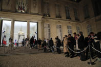 People line up to sign the condolences book to pay tribute to former President Jacques Chirac at the Elysee Palace, Thursday, Sept. 26, 2019. Jacques Chirac, a two-term French president who was the first leader to acknowledge France's role in the Holocaust and defiantly opposed the U.S. invasion of Iraq in 2003, has died Thursday at age 86. (AP Photo/Michel Euler)