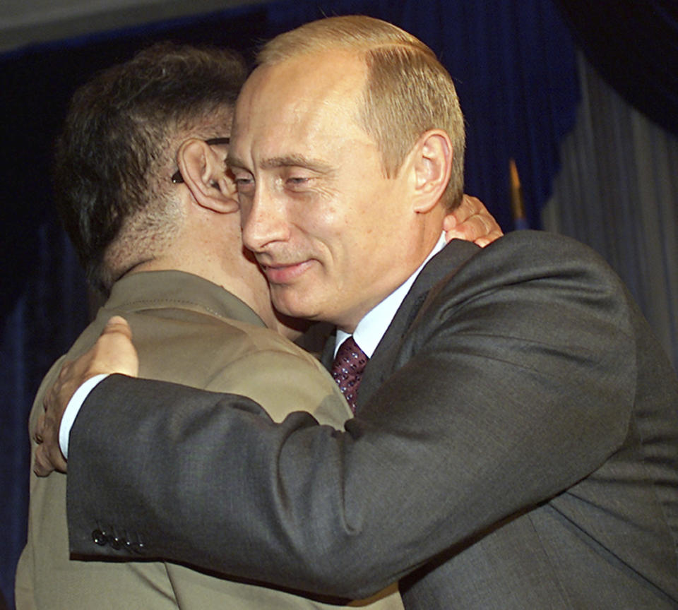 FILE - In this Aug. 23, 2002, file photo, Russian President Vladimir Putin, right, smiles as he hugs North Korean leader Kim Jong Il during their meeting in Vladivostok. North Korea on Tuesday, April 23, 2019, confirmed that leader Kim Jong Un, a son of Kim Jong Il, will soon visit Russia to meet with President Vladimir Putin. The summit would come at a crucial moment for tenuous diplomacy meant to rid the North of its nuclear arsenal, following a recent North Korean weapons test that likely signals Kim's growing frustration with deadlocked negotiations with Washington. (AP Photo/Alexander Zemlianichenko, File)