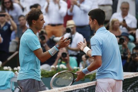 Rafael Nadal of Spain (L) shakes hands with Novak Djokovic of Serbia after winning their men's singles final match at the French Open Tennis tournament at the Roland Garros stadium in Paris June 8, 2014. REUTERS/Vincent Kessler