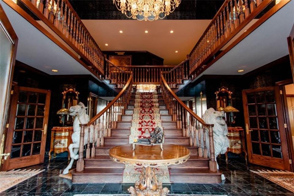 Mahogany and marble floors and a dual staircase are featured in the home at 7000 Pinegate Road.