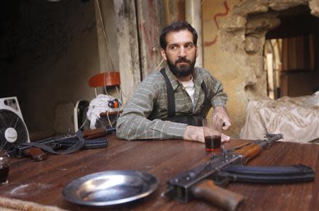 A Free Syrian Army fighter drinks tea as he rests in the old city of Aleppo September 11, 2013. REUTERS/Hamid Khatib