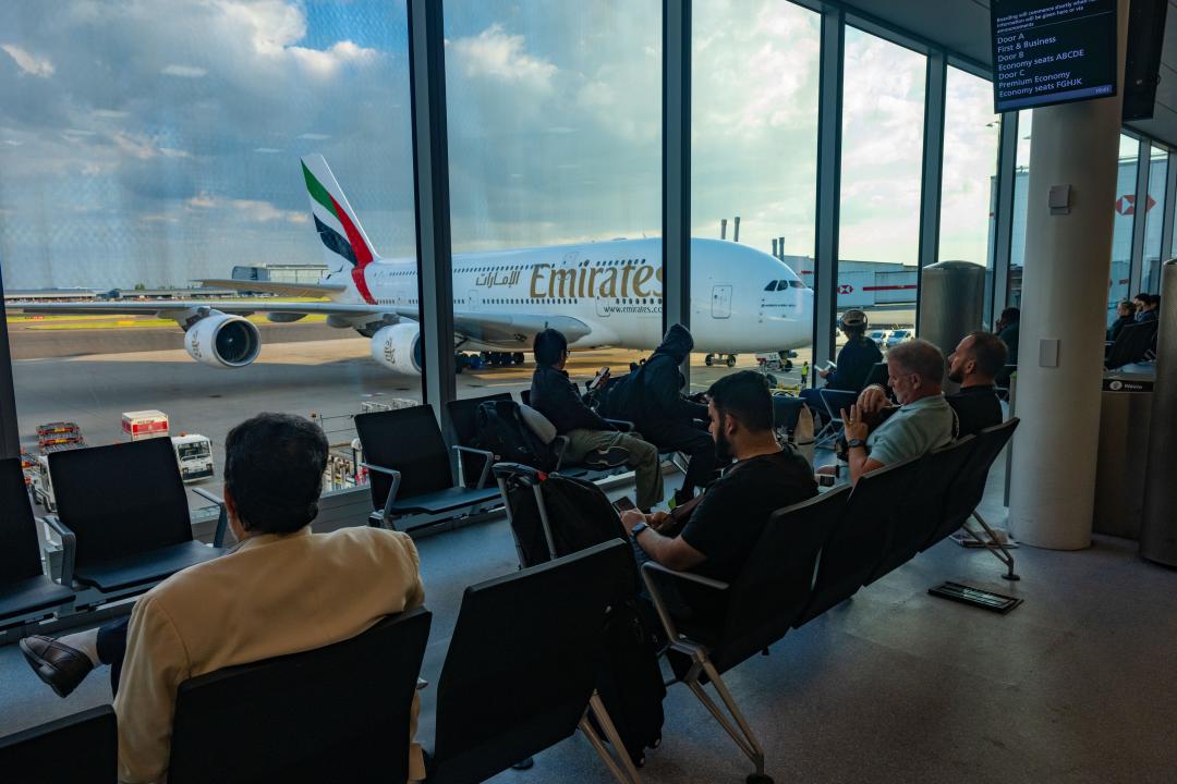 Passengers waiting in terminal to board on Emirates Airbus A380-800 at London Heathrow Airport