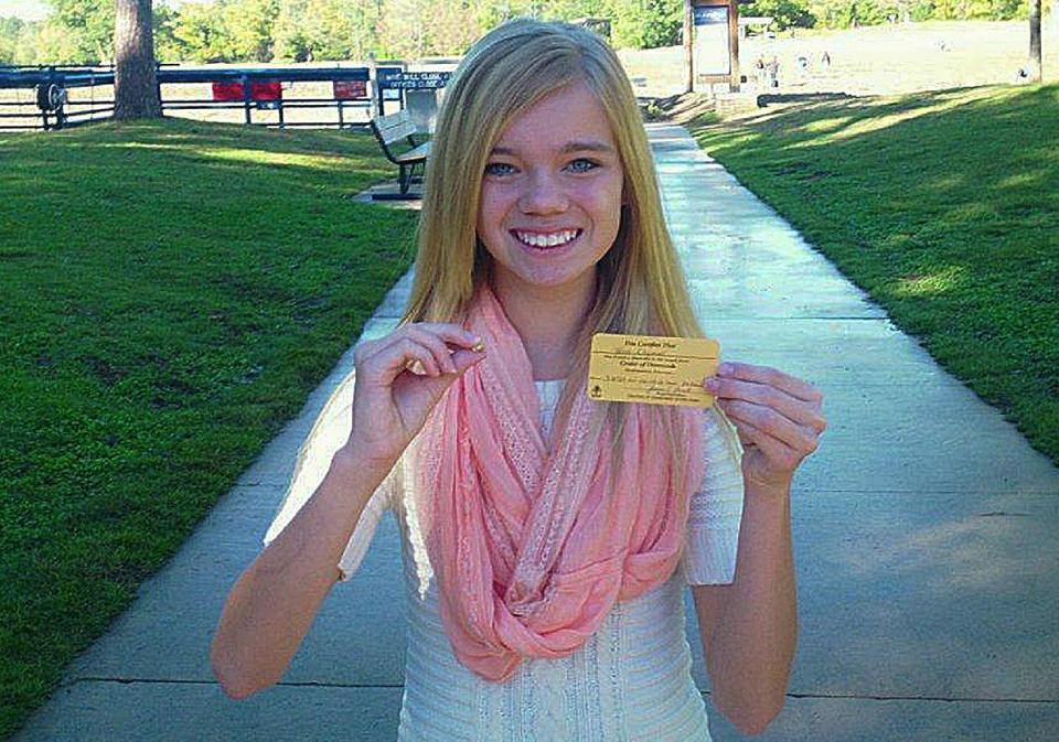 This photo provided by Crater of Diamonds State Park shows Tana Clymer, 14, of Oklahoma City, with a 3.85-carat canary diamond she discovered Saturday Oct. 19, 2013, at Arkansas' Crater of Diamonds State Park. The park is the only diamond-producing site in the United States that is open to the public. The yellow diamond is teardrop-shaped and about the size of a jellybean. (AP Photo/Crater of Diamonds State Park)