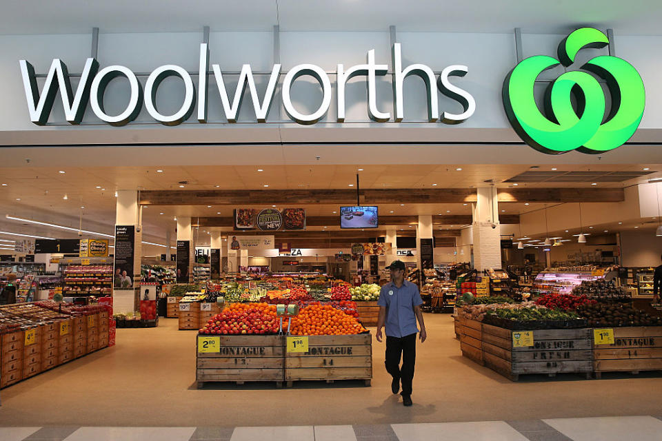 The front of a Woolworths store shows the supermarket sign and fruit and vegetable section in Sydney.