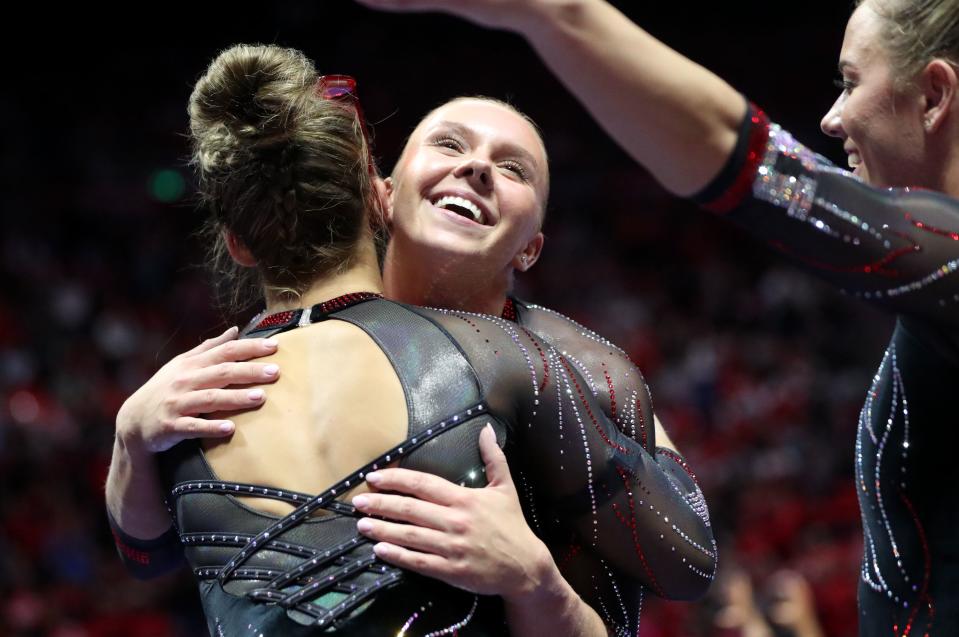 Utah’s Maile O’Keefe gets a hug after finishing a 10.0 beam routine as the Utah Red Rocks compete against Oregon State in a gymnastics meet at the Huntsman Center in Salt Lake City on Friday, Feb. 2, 2024. Utah won. | Kristin Murphy, Deseret News