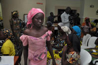 <p>Chibok schoolgirls recently freed from Boko Haram captivity are seen in Abuja, Nigeria, May 7, 2017. The 82 freed Chibok schoolgirls arrived in Nigeria’s capital on Sunday to meet President Muhammadu Buhari as anxious families awaited an official list of names and looked forward to reuniting three years after the mass abduction. (STR/AFP/Getty Images) </p>