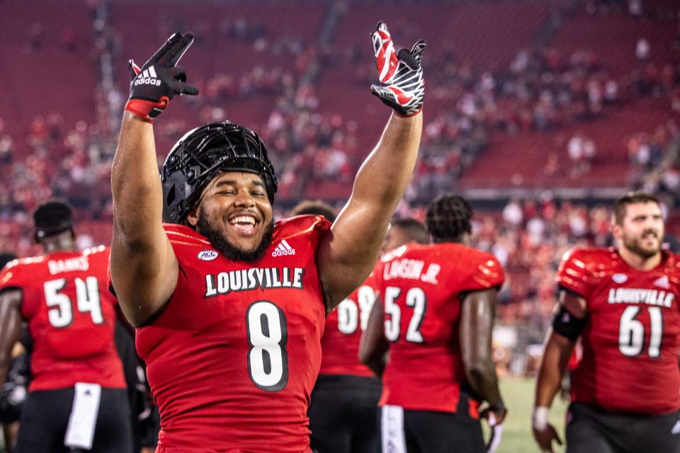 UofL's Henry Bryant celebrates on the sideline after the Louisville Cardinals beat UCF 42-35 after a wild end to the game with back-to-back interceptions and UofL returning one for a touchdown for the win. Sept. 17, 2021