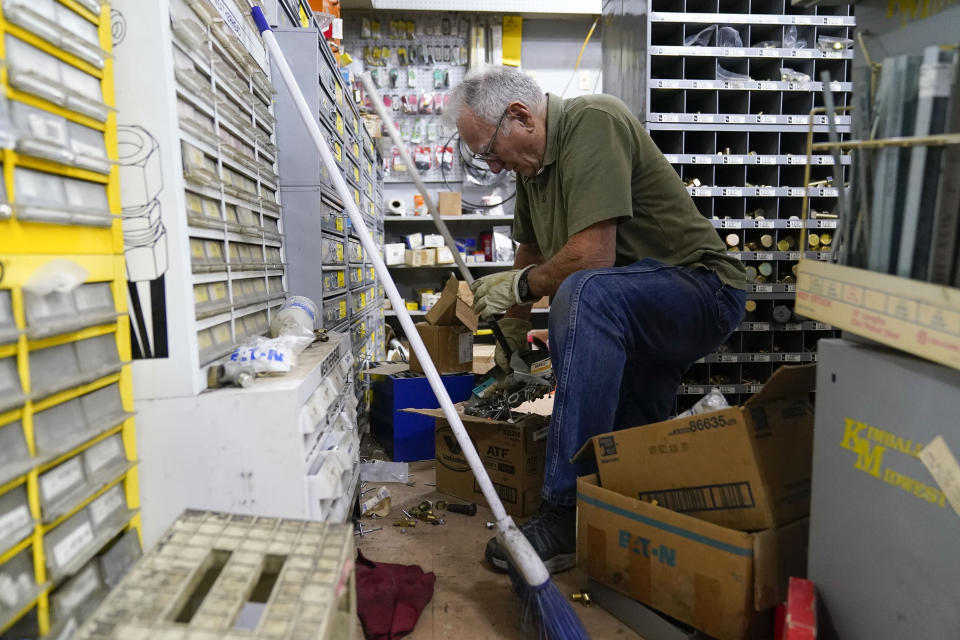 George Schauer cleans up inside an auto parts store after an earthquake in Rio Dell, Calif., Tuesday, Dec. 20, 2022. (AP Photo/Godofredo A. Vásquez)