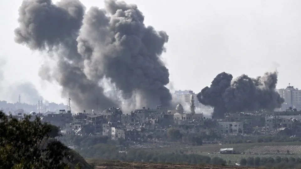 A picture taken from Sderot shows smoke plumes rising above buildings during an Israeli strike on the northern Gaza Strip on October 14. - Aris Messinis/AFP/Getty Images