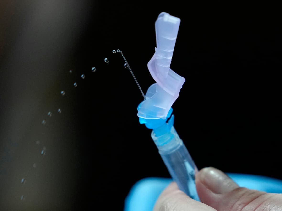 A health worker prepares Pfizer-BioNTech's COVID-19 vaccine at the National Kidney and Transplant Institute in Quezon City, Philippines, in November. (Aaron Favila/The Associated Press - image credit)