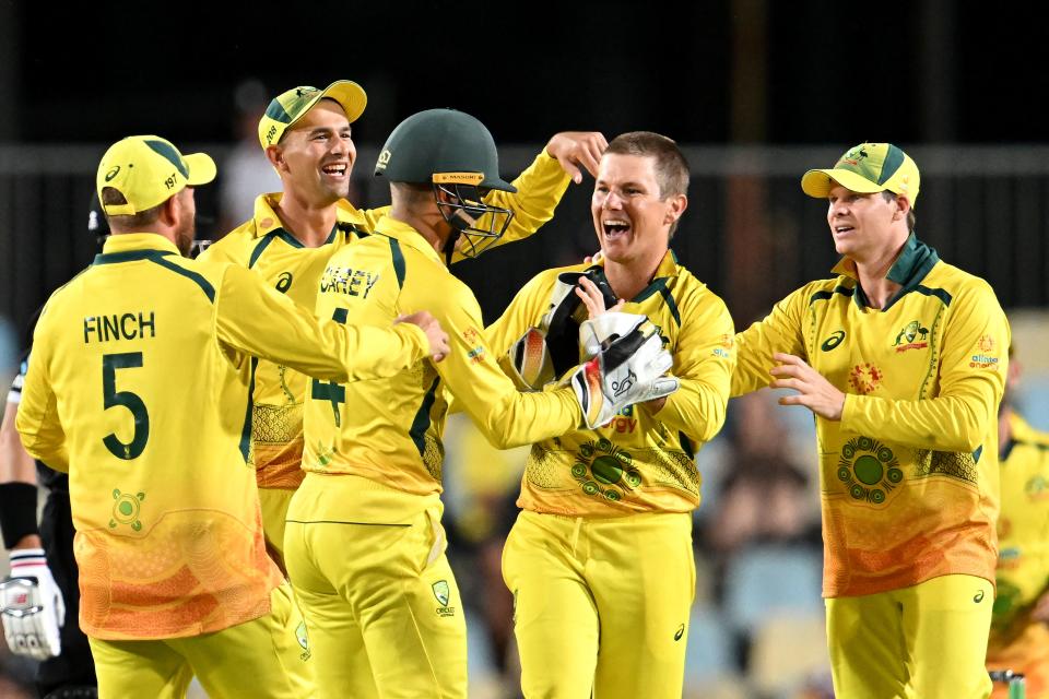 Pictured second from right, Australian Adam Zampa celebrates his wicket of Trent Boult in the second ODI in Cairns. 