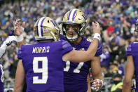 Washington tight end Cade Otton, right, celebrates his touchdown pass reception with quarterback Dylan Morris (9) in the first half of an NCAA college football game, Saturday, Sept. 18, 2021, in Seattle. (AP Photo/Elaine Thompson)