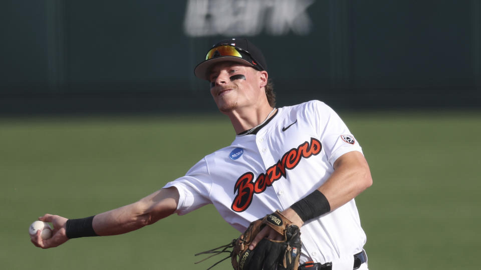 FILE - Oregon State infielder Travis Bazzana plays during an NCAA regional baseball game against Tulane on May 31, 2024, in Corvallis, Ore. Bazzana was taken by the Cleveland Guardians on Sunday, July 14, 2024, with the top pick in Major League Baseball’s amateur draft. (AP Photo/Amanda Loman, File)