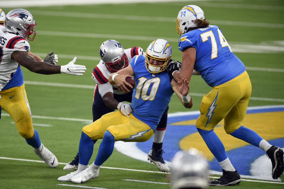 Los Angeles Chargers quarterback Justin Herbert (10) is sacked by New England Patriots defensive tackle Adam Butler during the second half of an NFL football game Sunday, Dec. 6, 2020, in Inglewood, Calif. (AP Photo/Kelvin Kuo)