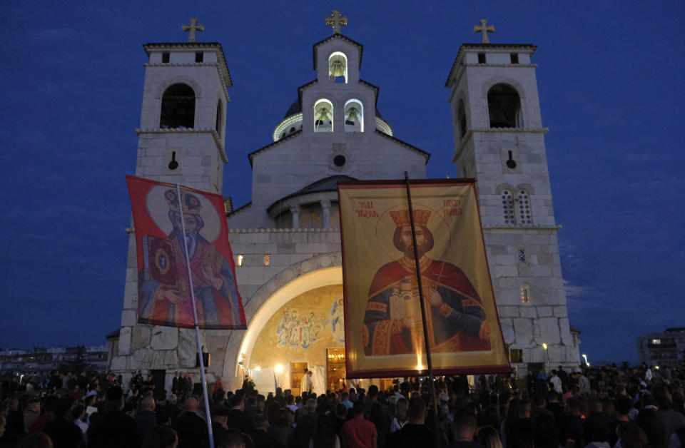 People gather for a protest prayer led by the Serbian Orthodox Church against the holding of an LGBTQ pride march this weekend in Podgorica, Montenegro, Friday, Oct. 7, 2022. The influential church has called its followers in Montenegro to join the prayer for "the sanctity of marriage and preservation of family" after organizing a similar gathering in neighboring Serbia ahead of a pan-European pride event there last month. (AP Photo/Risto Bozovic)