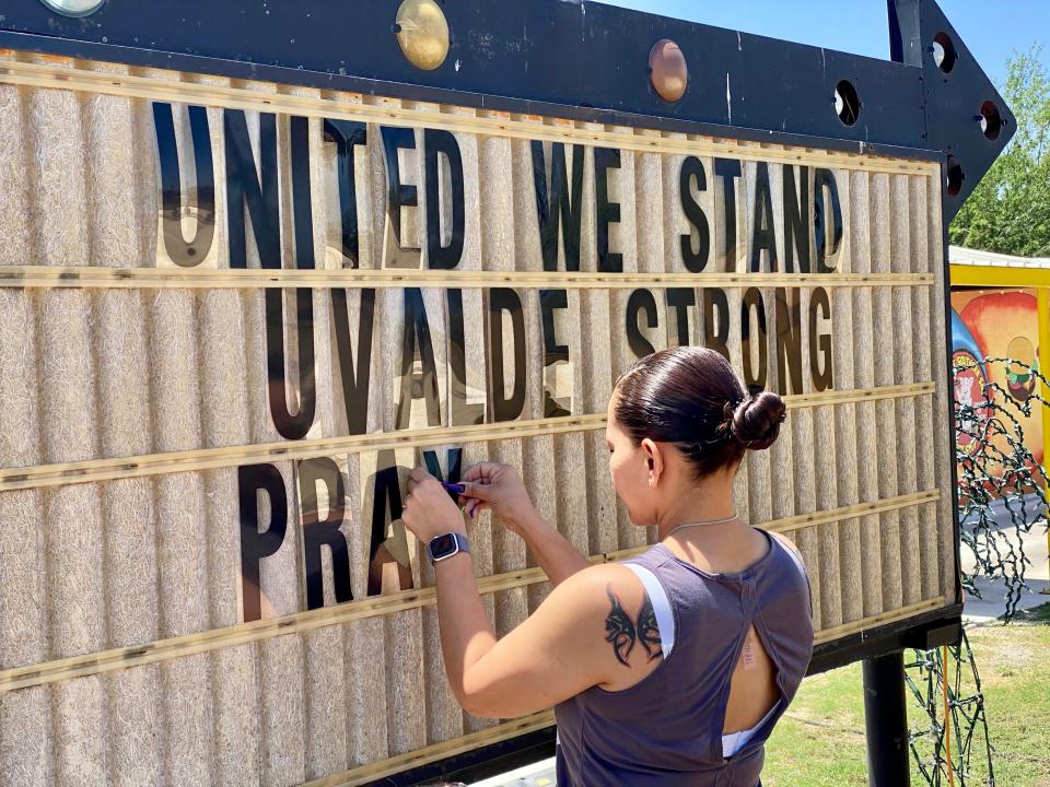 MaryAnn Garza, 37, completes a sign showing community support in Uvalde, Texas, on Wednesday, May 25, 2022, outside the Sno-Ink restaurant she owns with her husband.