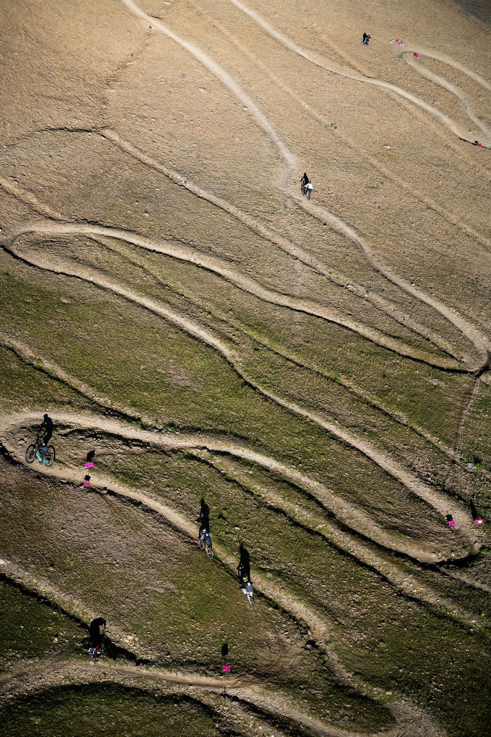 a group of people walking on a dirt road