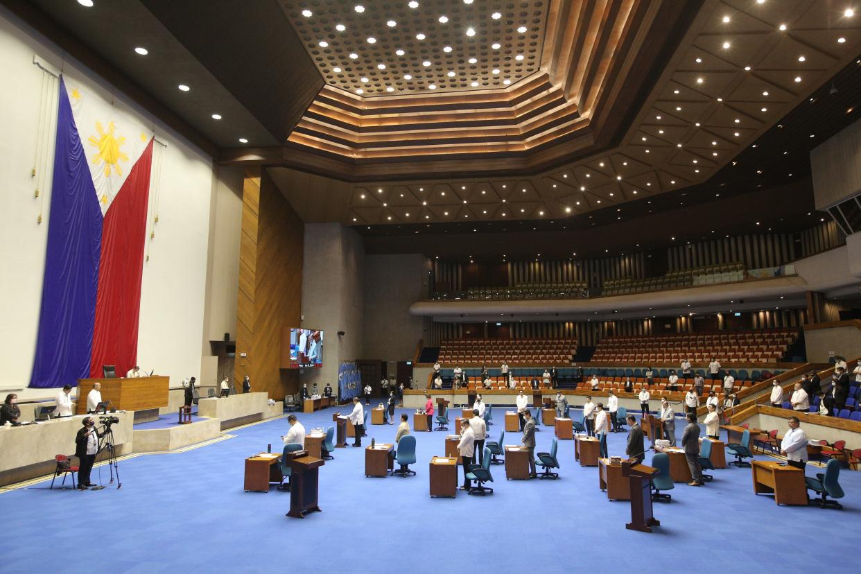 FILE PHOTO: Members of the Lower House of Congress attend a special session with desks arranged to observe social distancing amongst members in Manila on March 23, 2020, to discuss a proposed emergency power to be given to President Rodrigo Duterte to tackle the COVID-19 coronavirus outbreak. (Photo: STR/AFP via Getty Images)