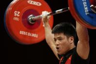 Li Fabin of China competes in the men's 61kg weightlifting event, at the 2020 Summer Olympics, Sunday, July 25, 2021, in Tokyo, Japan. (AP Photo/Luca Bruno)