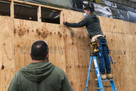 Ahead of the presidential election, workers board up a Pret A Manger restaurant along K Street NW, Friday, Oct. 30, 2020, in downtown Washington not far from the White House. (AP Photo/Jacquelyn Martin)