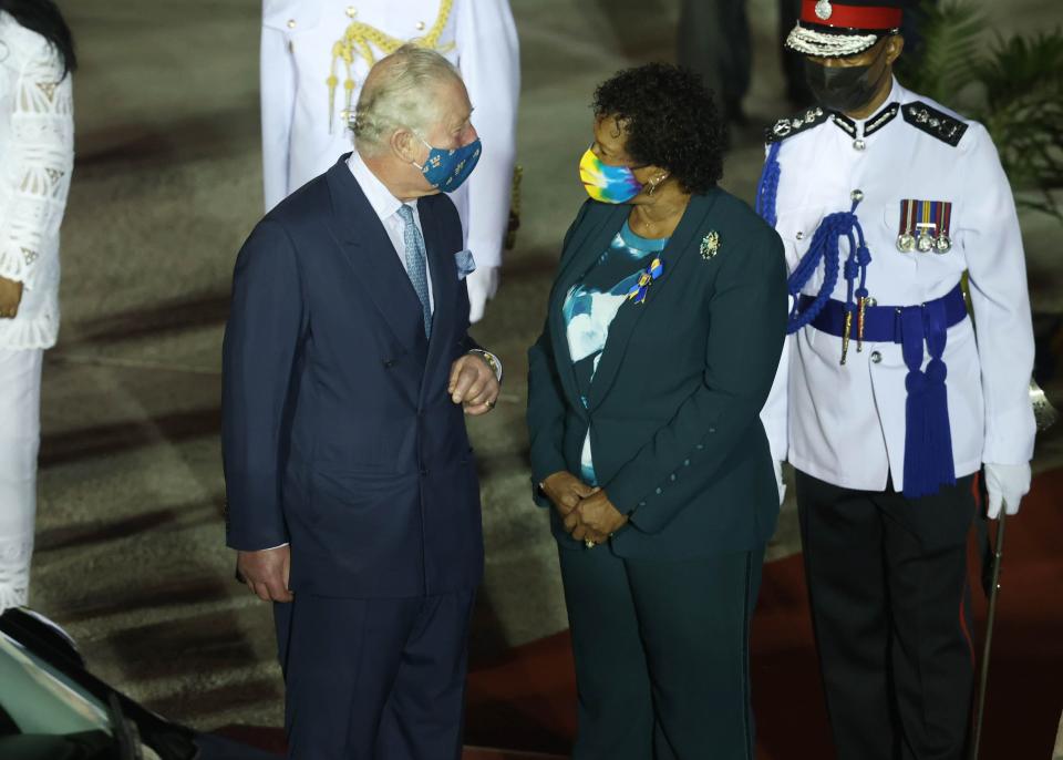 Prince Charles, Prince of Wales, is greeted by Dame Sandra Mason (in green) as he arrives at Bridgetown Airport on Nov. 28, 2021, in Bridgetown, Barbados. The Prince of Wales arrived in the country ahead of its transition to a republic within the Commonwealth.
