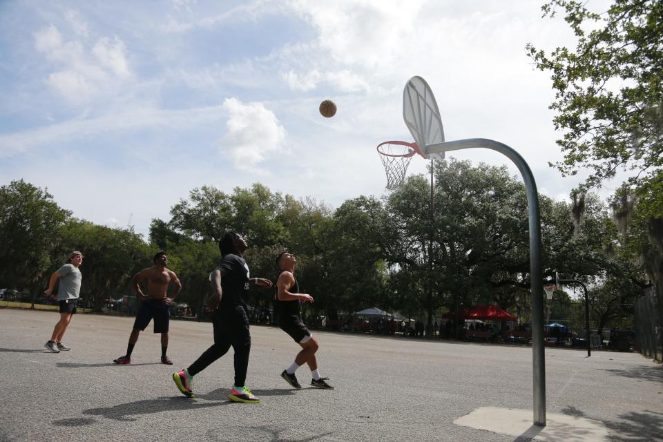 Visitors enjoy a game of basketball at Forsyth Park.