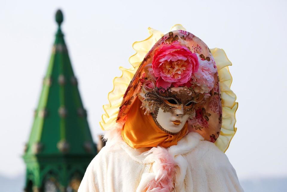 A reveller poses in Saint Mark’s Square during the Carnival in Venice