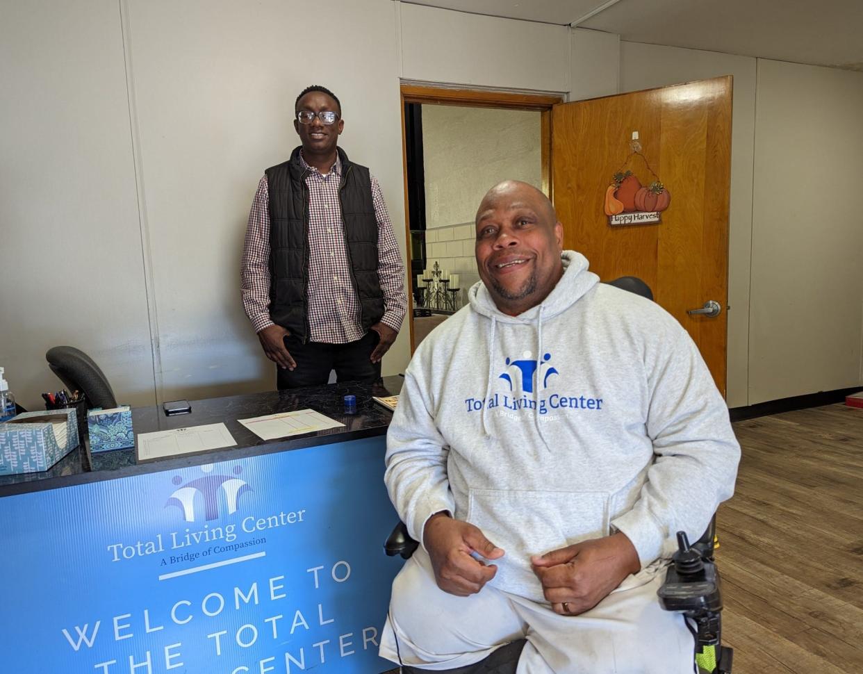 Volunteer Charley Baldwin, right, is now a regular volunteer at the Total Living Center in Canton. The Rev. Ben Kariuki, left, said Baldwin's story is one that needs to be shared.