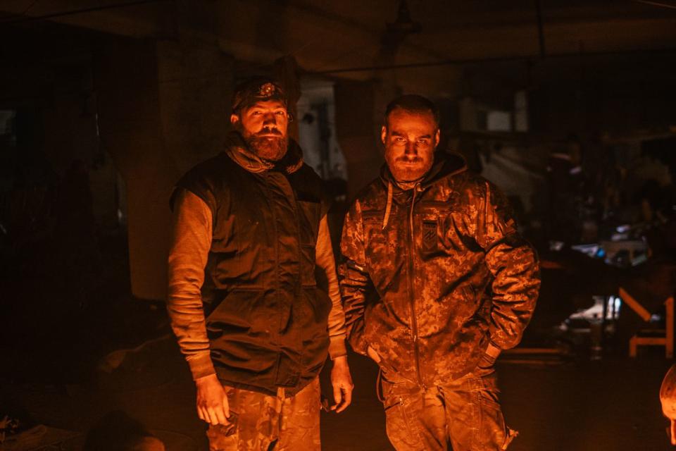 Two Ukrainian soldiers stand near the fire in the bunker of the Azovstal steel plant in Mariupol, Ukraine on May 7, 2022. (Personal archive / Dmytro Kozatskyi)