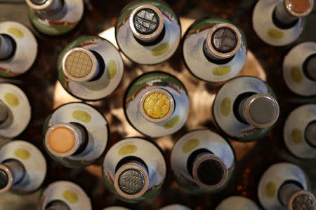 The leather tops of TX Whiskey and TX Bourbon bottles are photographed at the Firestone & Robertson (F&R) Whiskey Ranch in Forth Worth, Texas, U.S., May 24, 2018. REUTERS/Adrees Latif