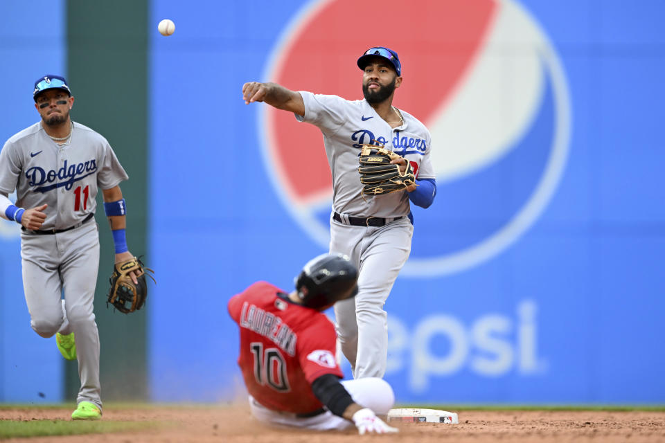 Los Angeles Dodgers' Amed Rosario forces out Cleveland Guardians' Ramón Laureano (10) at second base and throws out Eric Haase at first base to complete a double play during the eighth inning in the continuation of a suspended baseball game, Thursday, Aug. 24, 2023, in Cleveland. The game was suspended the night before due to inclement weather. (AP Photo/Nick Cammett)