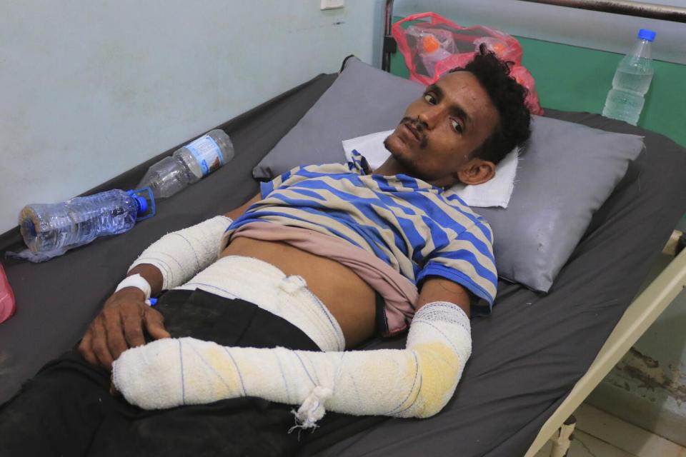 A man is lying down with his arms and torso bandaged.