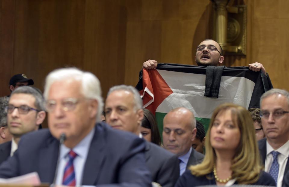 Taher Herzallah, holding a Palestinian flag, interrupts David Friedman, nominated to be U.S. ambassador to Israel, as he testifies before the Senate Foreign Relations Committee on Feb. 16. (Photo: Susan Walsh/AP)