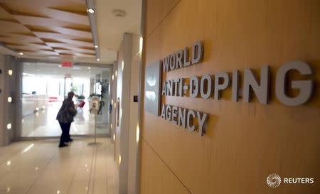 A woman walks into the head office for the World Anti-Doping Agency (WADA) in Montreal, November 9, 2015. REUTERS/Christinne Muschi