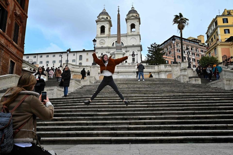 A different tourist poses for a picture in front of the empty Spanish Steps in 2020. (AFP via Getty Images)