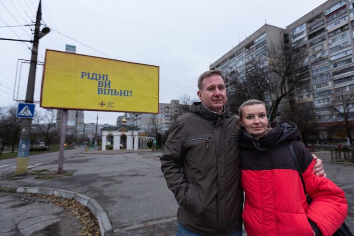 <div class="inline-image__caption"><p>Kostyantyn Babenko and Hanna Aleksandrova in front of a Ukrainian billboard in Kherson that reads "Countrymen, you are free!"</p></div> <div class="inline-image__credit">Daniel Brown</div>