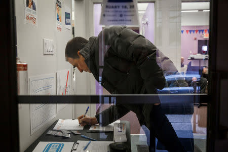 An attendee signs in to a campaign event held for Congressional candidate Conor Lamb in Carnegie, Pennsylvania, U.S., February 16, 2018. Picture taken February 16, 2018. REUTERS/Maranie Staab