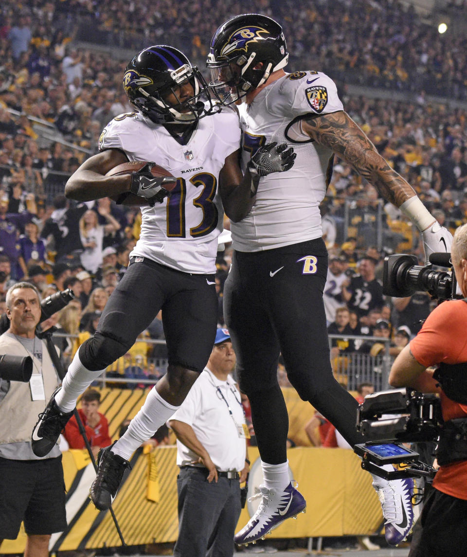 Baltimore Ravens wide receiver John Brown (13) celebrates with Maxx Williams after a 33 yard touchdown reception in the first half of an NFL football game against the Pittsburgh Steelers in Pittsburgh, Sunday, Sept. 30, 2018. (AP Photo/Don Wright)